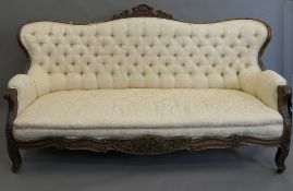 A Victorian button upholstered mahogany framed settee. Approximately 205 cm wide.