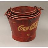 A set of three coke buckets. The largest 25 cm high including handle.