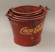 A set of three coke buckets. The largest 25 cm high including handle.