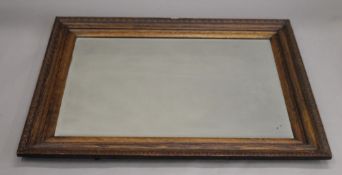 An early 20th century oak framed mirror. 113 x 82 cm.