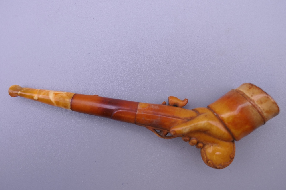 A cased 19th century meerschaum and amber pipe formed as a hand holding a pistol. 12 cm long. - Image 3 of 13