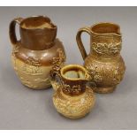 Three salt glazed jugs. The largest 16 cm high.