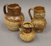 Three salt glazed jugs. The largest 16 cm high.