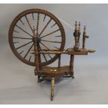 An antique spinning wheel. 94 cm wide.