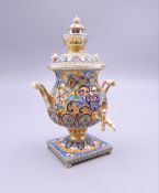 A miniature enamel decorated silver gilt samovar, bearing Russian marks. 10 cm high.