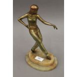 An Art Deco patinated spelter figure of a dancing lady. 27 cm high.