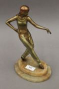 An Art Deco patinated spelter figure of a dancing lady. 27 cm high.