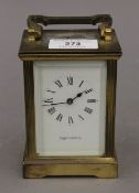 A Mappin and Webb carriage clock. 11 cm high excluding handle.