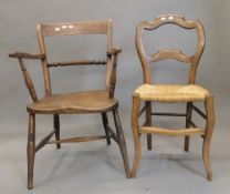 A 19th century elm seated rope back open armchair and a rush seated chair. The former 54 cm wide.