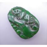 A carved jade pendant. 5.5 cm high.