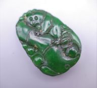 A carved jade pendant. 5.5 cm high.