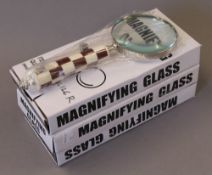 Three boxed magnifying glasses.