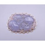 A 9 ct gold mounted lavender jade brooch. 5.5 cm wide.