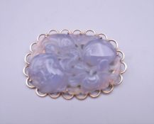 A 9 ct gold mounted lavender jade brooch. 5.5 cm wide.