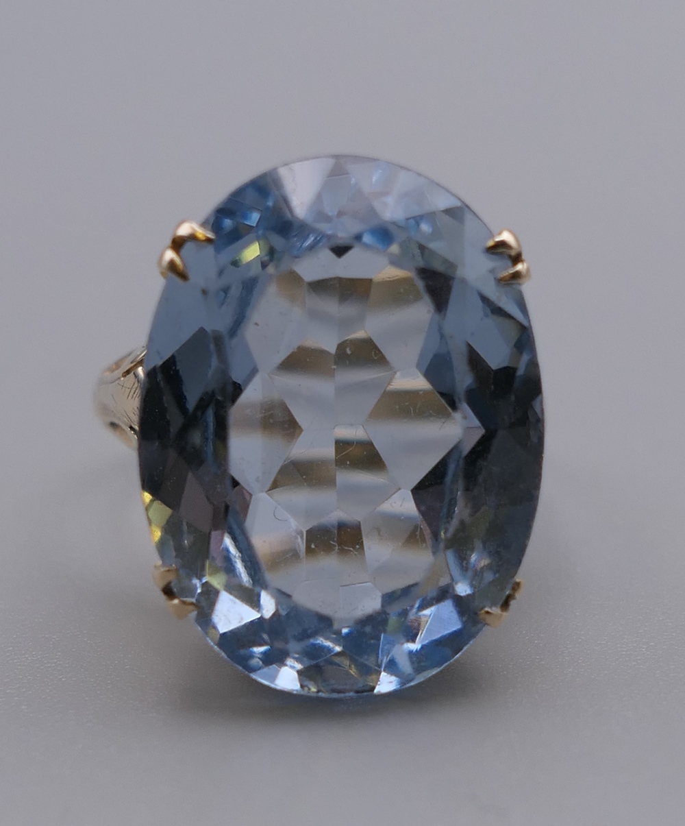 A 9 ct gold ring set with a large light blue aquamarine. Ring size P/Q. 7.2 grammes total weight. - Image 6 of 8
