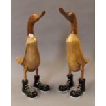 A pair of wooden ducks in boots. 46.5 cm high.