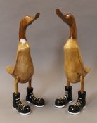 A pair of wooden ducks in boots. 46.5 cm high.