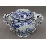 A large Nevers blue and white faience lidded twin handled flower vase. 25 cm high.