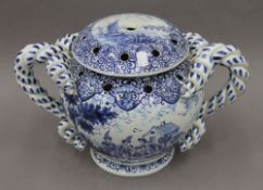 A large Nevers blue and white faience lidded twin handled flower vase. 25 cm high.