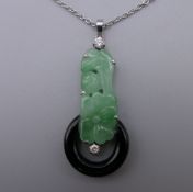 An Art Deco jade and onyx pendant set on platinum on a platinum chain. The pendant 4 cm high.