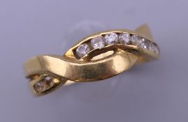 A gold ladies crossover band ring. Ring size K. 4 grammes.