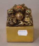 A Chinese gilt bronze dragon seal. 8.5 cm high.