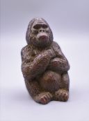 A bronze model of a gorilla. 4.5 cm high.