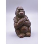 A bronze model of a gorilla. 4.5 cm high.