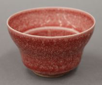 A Chinese red porcelain tea bowl. 6 cm high.