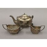A silver composite bachelor's tea set. The teapot 10.5 cm high. 12.6 troy ounces.