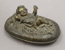 A 19th century bronze oval box, the lid decorated with a young child. 15 cm wide.