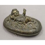 A 19th century bronze oval box, the lid decorated with a young child. 15 cm wide.