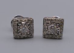 A pair of 18 ct white gold Art Deco style square diamond ear studs. 7 mm square.