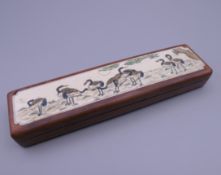 A bone and wooden box, the lid decorated with cranes. 15.5 cm long.