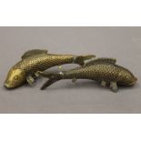 A pair of Oriental cast brass models of carp, with butterfly character marks to base.