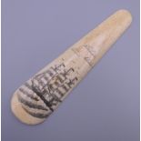 A bone shoe horn decorated with a ship. 15 cm long.