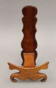 A Chinese carved hardwood plate stand. 32 cm high.