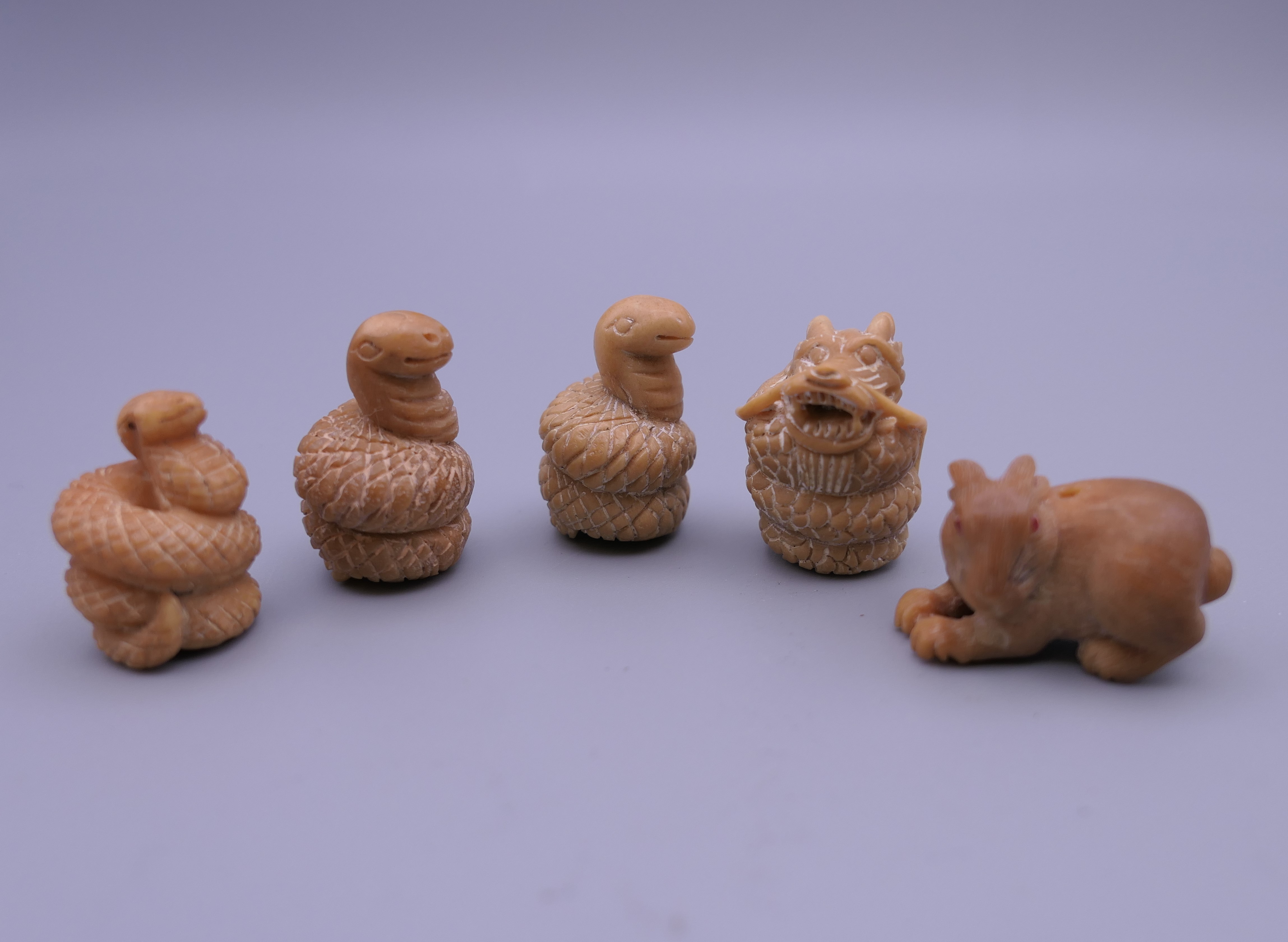 Five small carved netsukes.