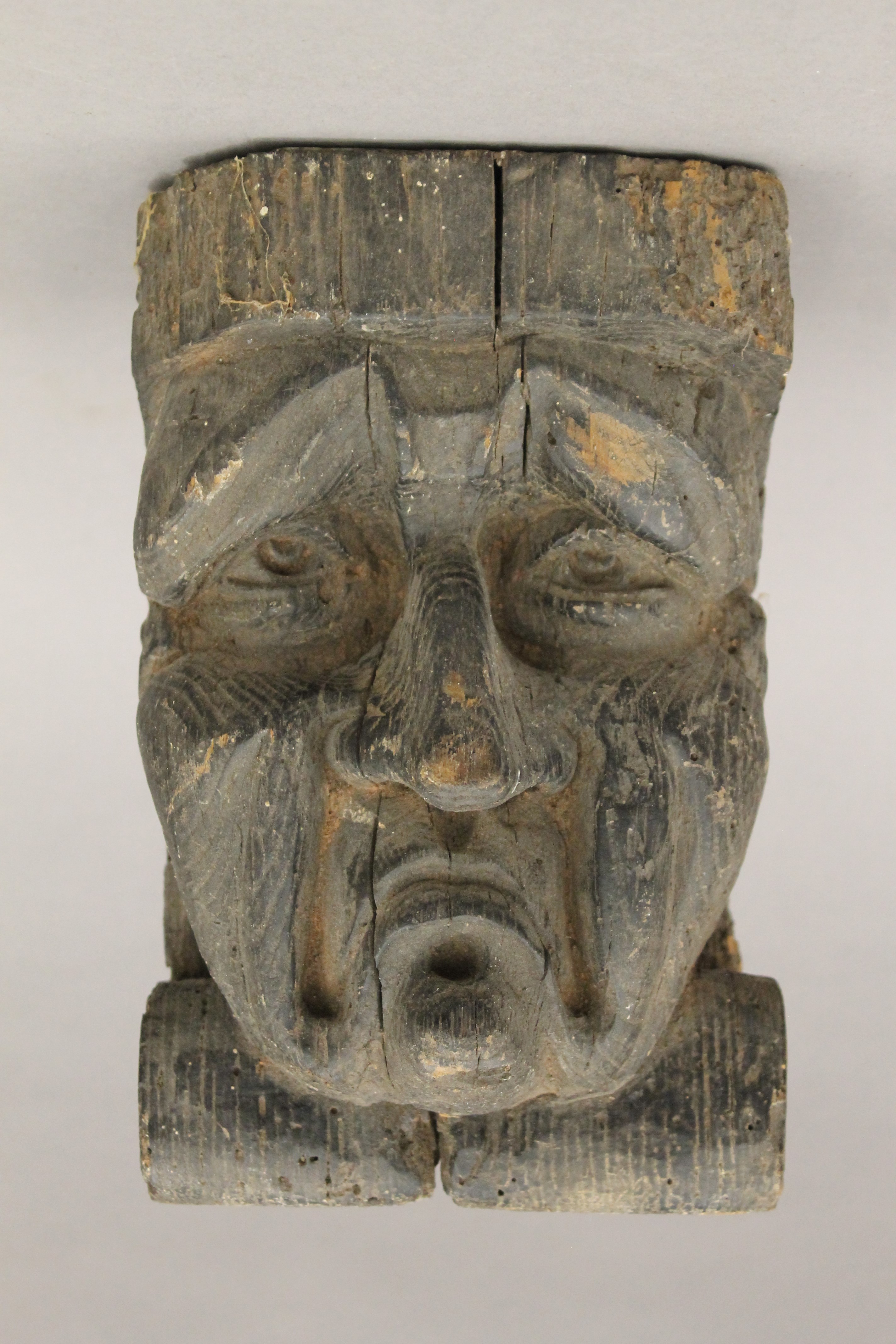 An early carved oak grotesque mask, possibly 17th century or earlier. 23 cm high.