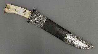 A bowie knife in a white metal mounted sheath. 37.5 cm long.