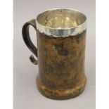 An early leather covered Scottish silver tankard. 18.5 cm high. 18 troy ounces total weight.