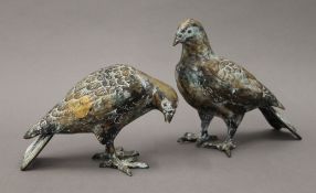 Two patinated white metal models of pigeons. The largest 18.5 cm high.