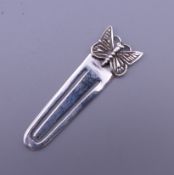 A silver bookmark formed as a butterfly. 4.25 cm high.