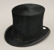A vintage silk top hat. Interior measurement 19 x 15.25 cm.