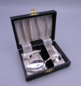 A boxed set of silver baby's cutlery (spoon and food pusher), hallmarked for Birmingham 1947.