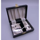 A boxed set of silver baby's cutlery (spoon and food pusher), hallmarked for Birmingham 1947.