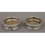 A pair of silver coasters. 16 cm diameter. 21.3 troy ounces total weight.