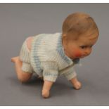 A vintage German clockwork crawling baby. 13.5 cm high.