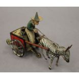 A Lehman tin plate clockwork model of a zebra and cart. 18 cm long.