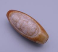 A carved agate zhi bead. 5 cm high.